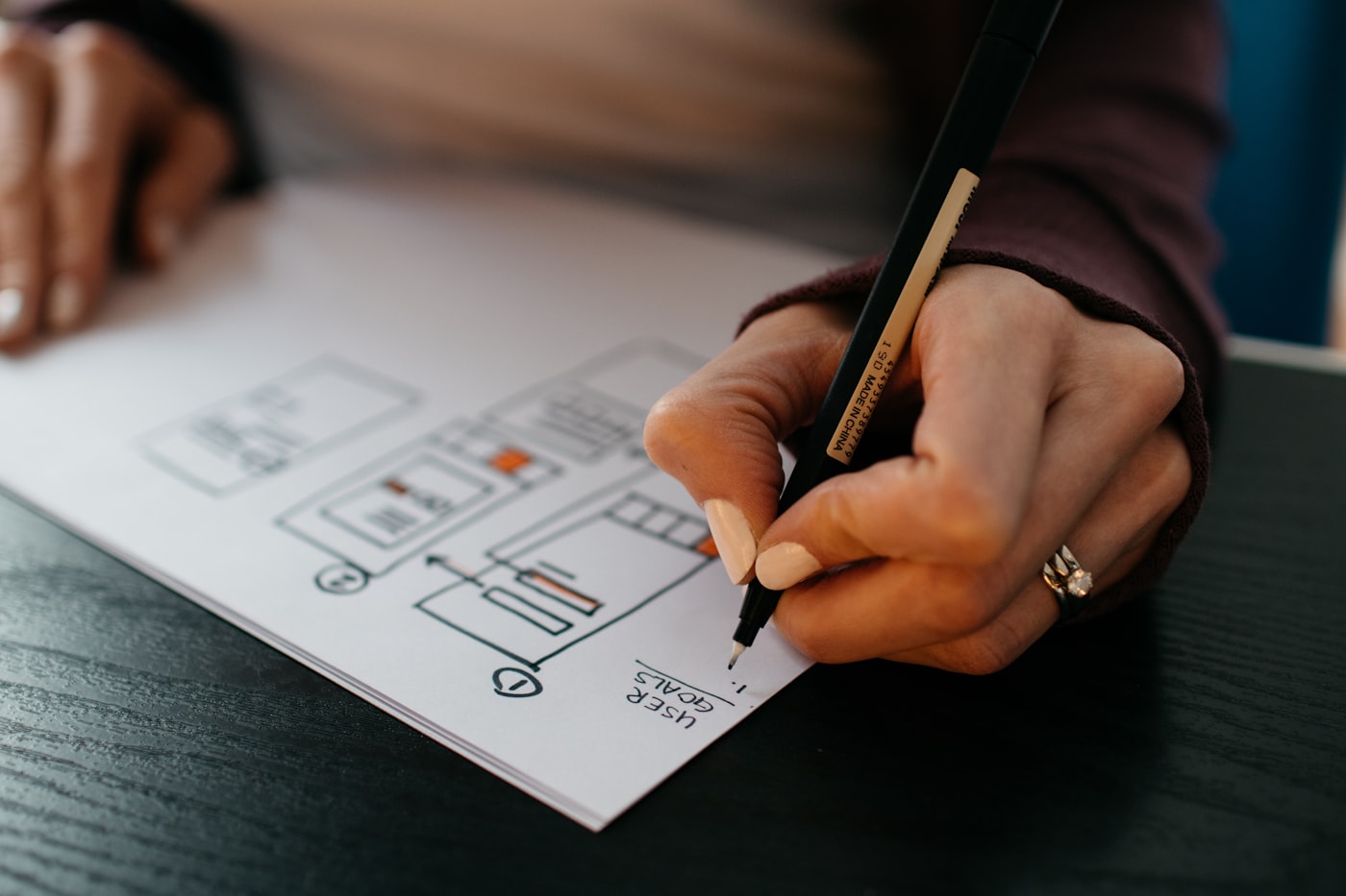 A page layout being sketched as a wireframe on paper